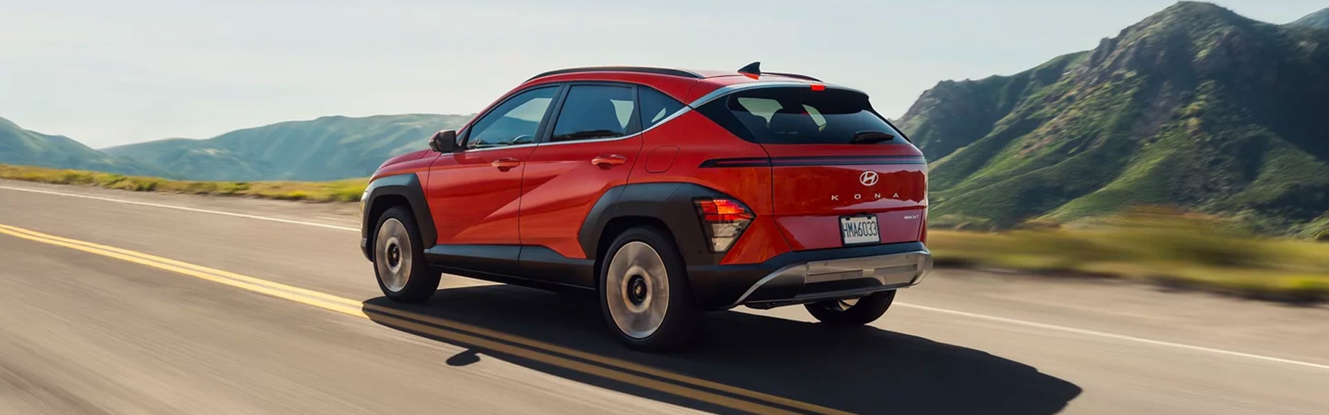rear view of hyundai kona driving on road