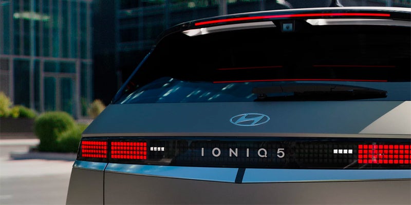Rear view of a Hyundai IONIQ 5 electric car, featuring pixelated LED taillights and "IONIQ 5" typography.